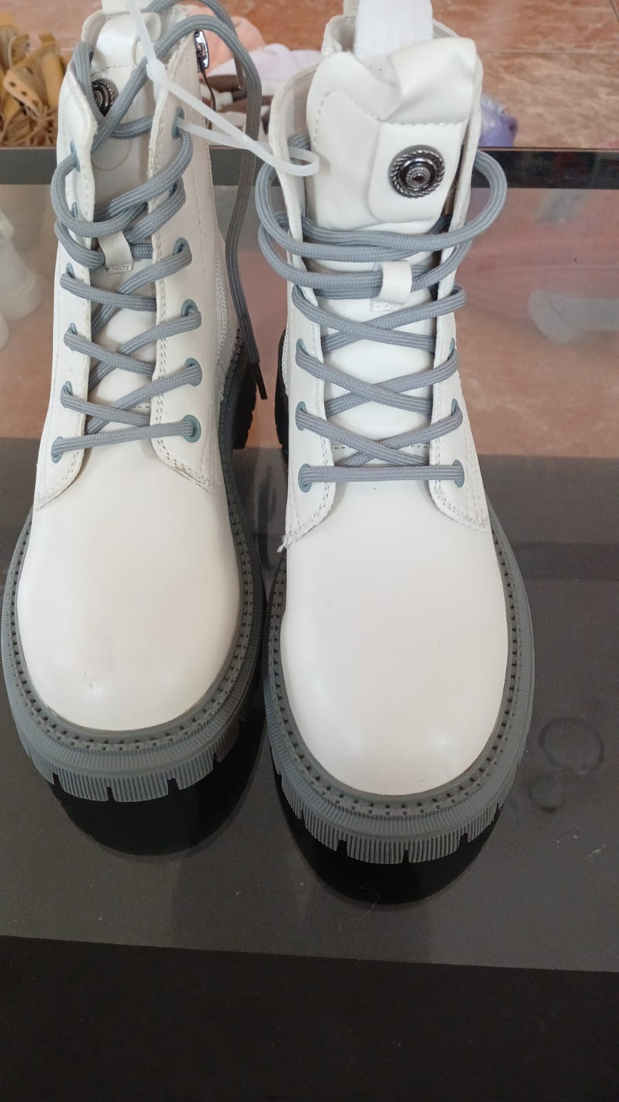 Lace-up ankle boots feature a gray thick-treaded sole